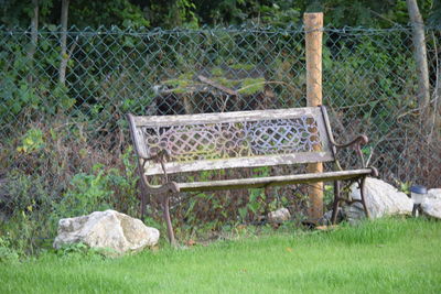 Close-up of metal fence on field