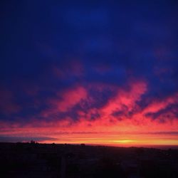 Silhouette landscape against romantic sky at sunset