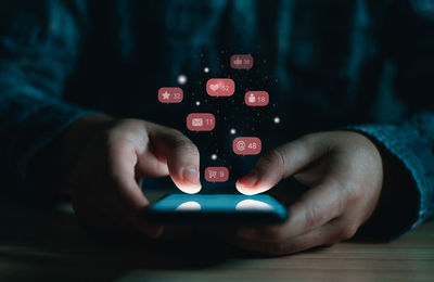 Midsection of man using mobile phone