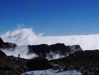 Scenic view of mountains against clear blue sky