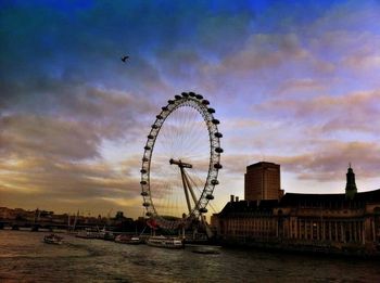 Ferris wheel against cloudy sky