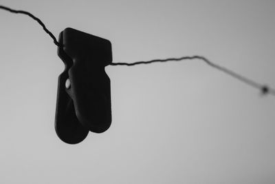 Low angle view of silhouette barbed wire against sky