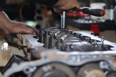 Cropped hand of man working in garage