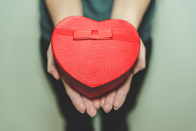 Close-up of woman holding heart shape