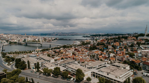 High angle view of townscape by sea against sky