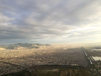 Cityscape against cloudy sky