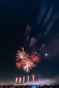 Low angle view of firework display at night