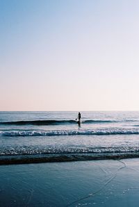 Man in sea against clear sky