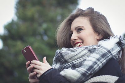 Young woman using mobile phone outdoors