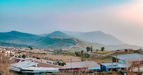 High angle view of buildings and mountains against sky