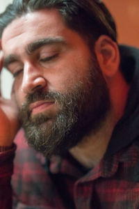 Close-up of bearded man with eyes closed