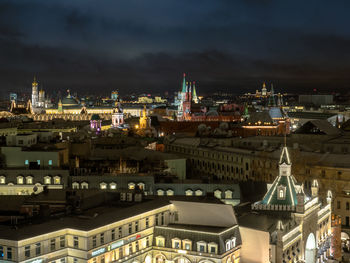 Illuminated cityscape against sky at night