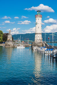 View of lighthouse by sea against sky