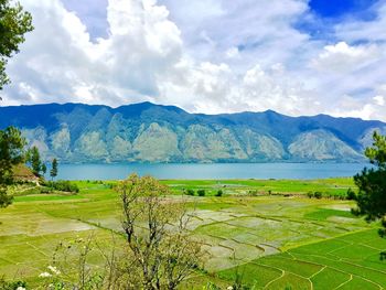 Scenic view of lake against cloudy sky