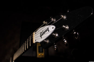 Close-up of guitar against black background