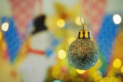 Close-up of christmas decorations hanging on metal