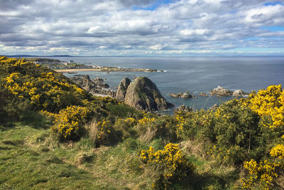 Scenic view of sea against cloudy sky