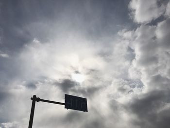 Low angle view of road sign against sky