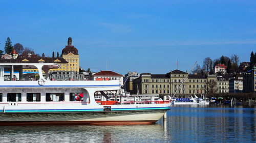 The stern of a passenger ship on lake lucerne with the city of lucerne in the background