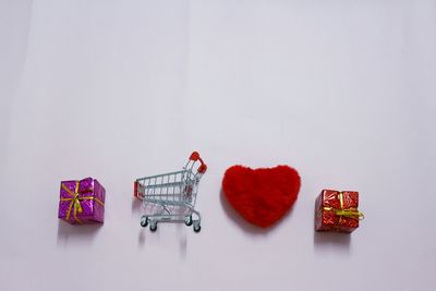 Multi colored heart shape on table against white background