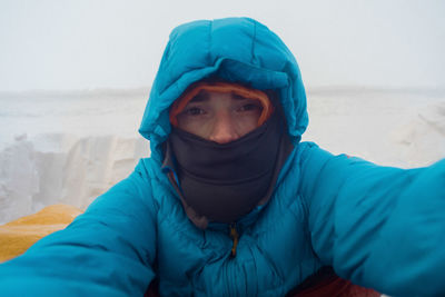 Portrait of man on snow covered field during winter