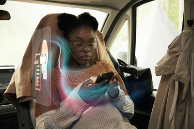 Woman reading fake news on cell phone