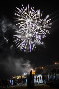 Low angle view of firework display at night