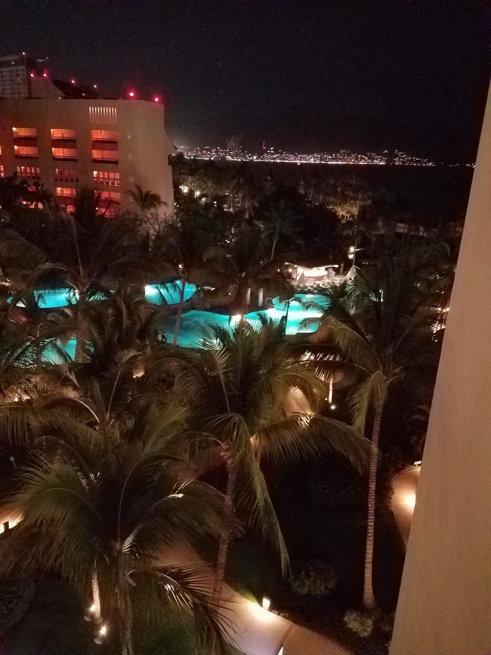 PANORAMIC VIEW OF ILLUMINATED CITY BUILDINGS AT NIGHT