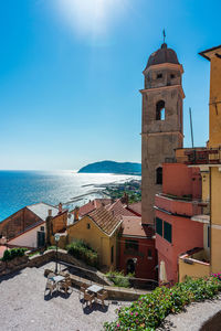 High angle view of townscape by sea against sky