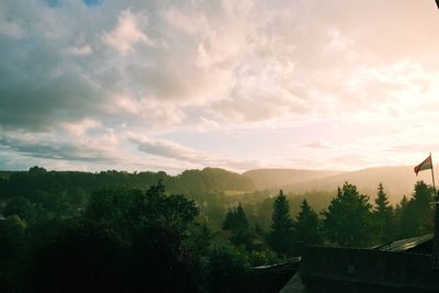 Scenic view of mountains against cloudy sky
