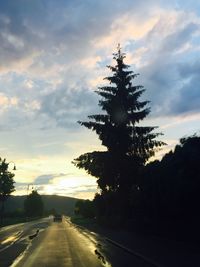 Road against cloudy sky at sunset