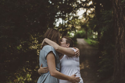 Rear view of mother and daughter on tree