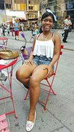 Portrait of a young woman sitting on bench