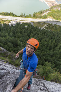 Man lead climbing a multipitch climb looking concerned about next move