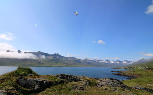 Scenic view of lake against cloudy sky