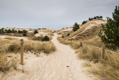 Panoramic view of sand dunes against sky