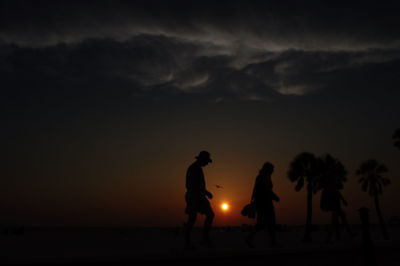 Silhouette people at sunset