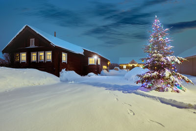 Built structures on snow covered landscape against sky