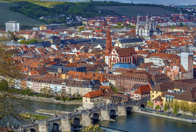 High angle view of illuminated city by river