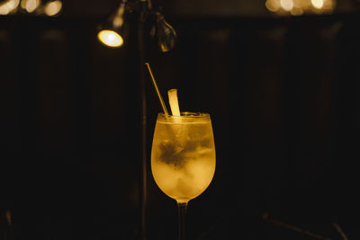 Close-up of drink in glass on table at night