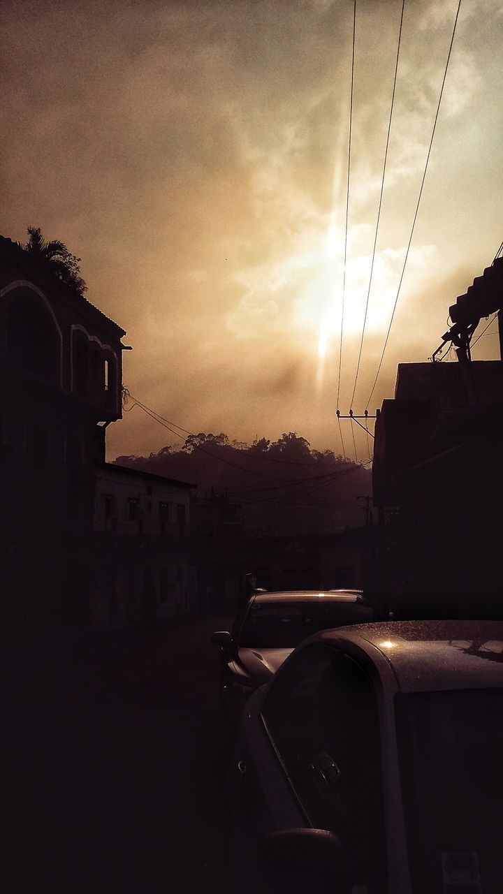 CAR ON ROAD AGAINST SKY DURING SUNSET