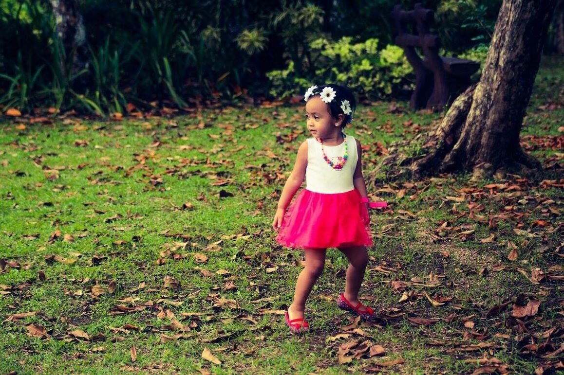 GIRL STANDING IN FIELD