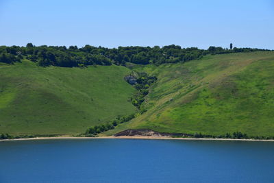 Scenic view of dniester river by mountain against sky