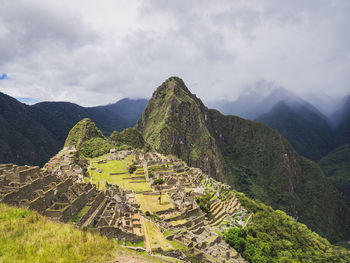 Scenic view of mountains against cloudy sky