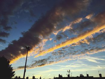 Low angle view of silhouette trees against sky during sunset