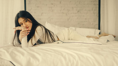 Young woman sleeping on bed at home