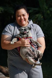 Low section of woman holding dog