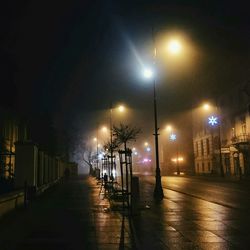 Empty illuminated street lights at night