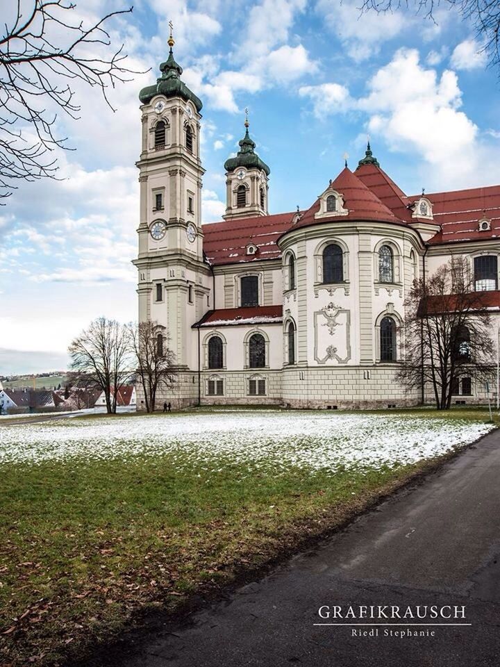 building exterior, religion, architecture, church, built structure, place of worship, sky, spirituality, cloud - sky, cross, cathedral, tree, facade, street, cloud, road, day, dome