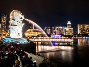 Illuminated city buildings at waterfront